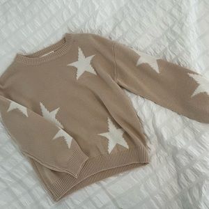 tan sweater with white stars, soft material, machine washable
